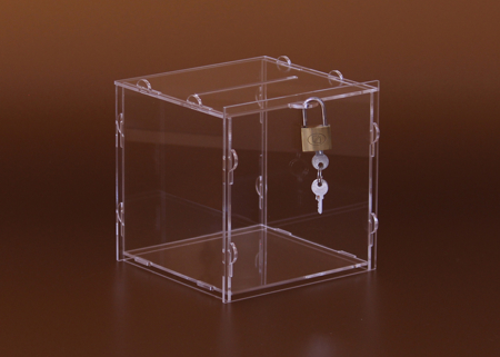 Kocka alakú adománygyűjtő doboz, persely, lapra szerelt kivitelben, a doboz lakattal zárható, melyhez 3 db kulcs tartozik.